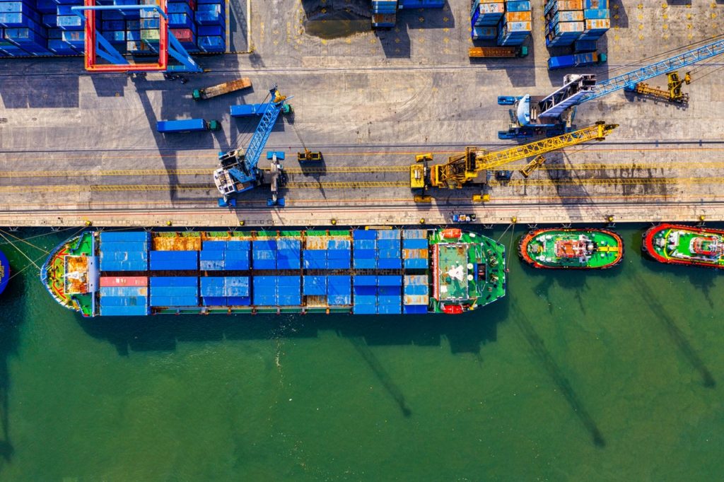 aerial shot of cargo ship and cranes